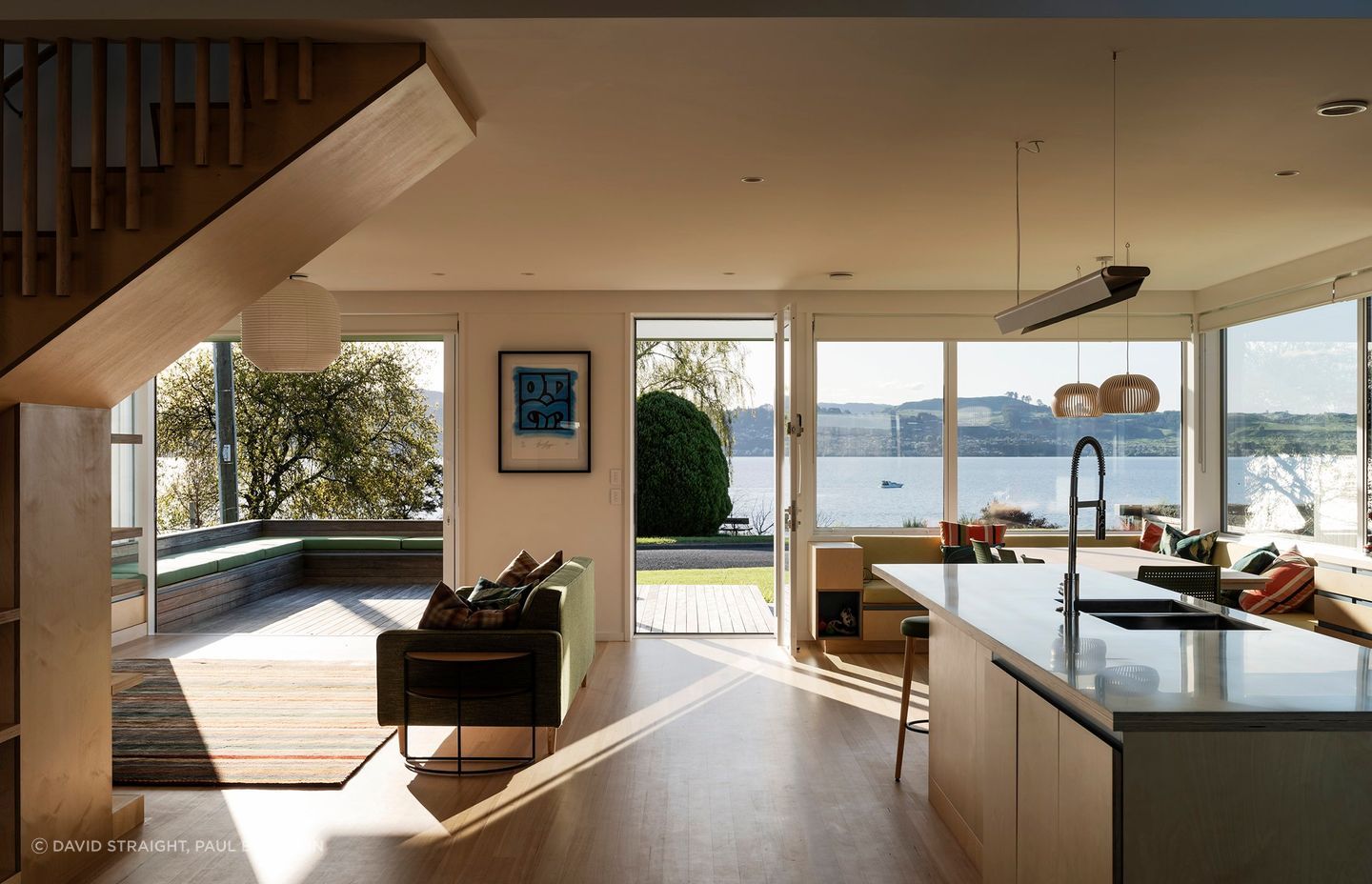 The interior living, kitchen, and dining areas flow freely onto outdoor decks, forming a large meeting space for family and friends. 