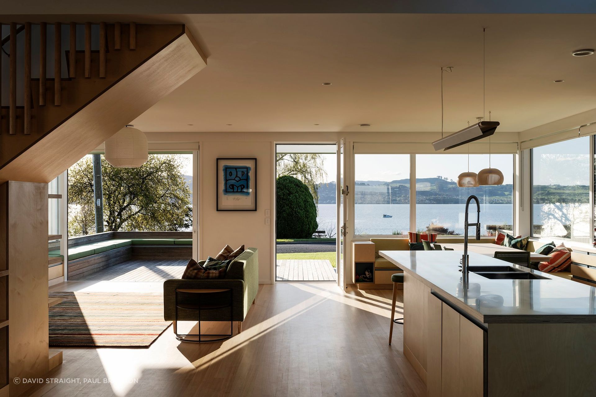 The interior living, kitchen, and dining areas flow freely onto outdoor decks, forming a large meeting space for family and friends. 