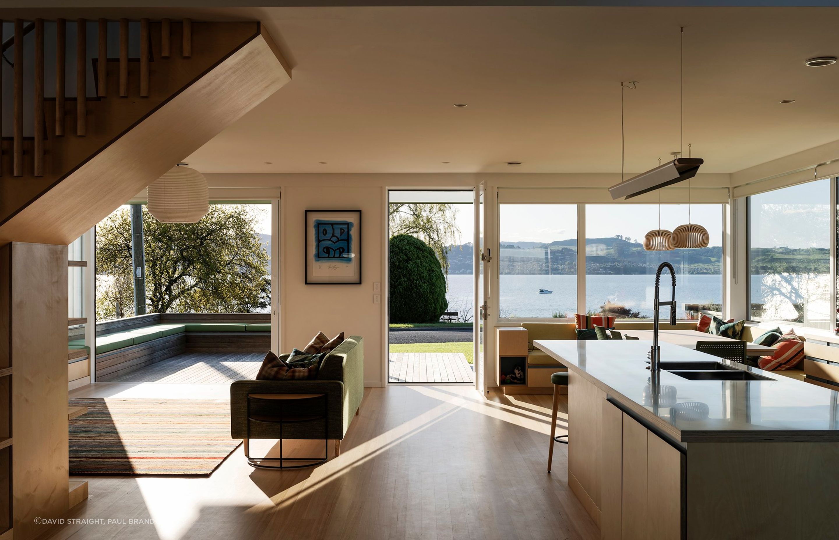 The interior living, kitchen, and dining areas flow freely onto outdoor decks, forming a large meeting space for family and friends.