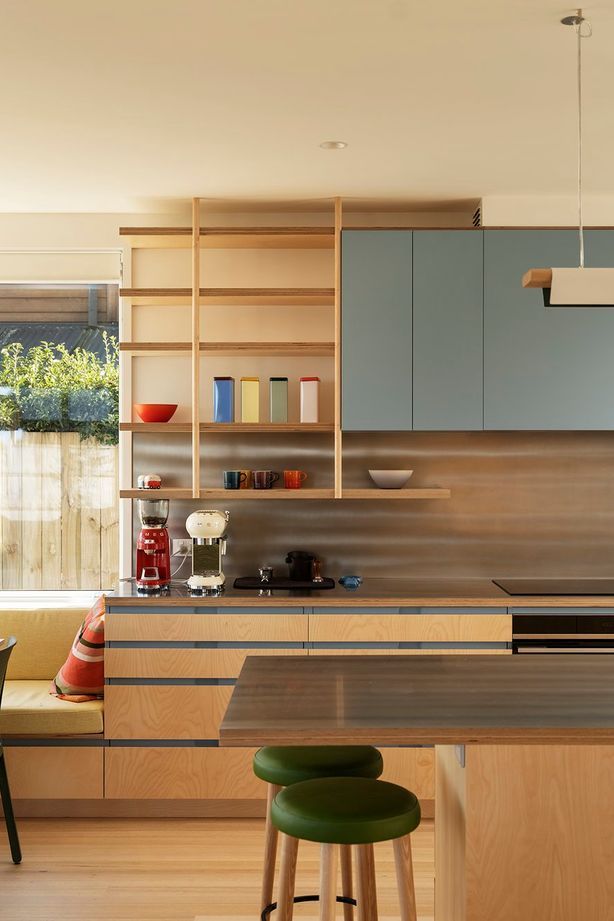 The interior palette features Victorian ash timber and birch ply cabinetry; soft, off-white walls; and pops of colours.