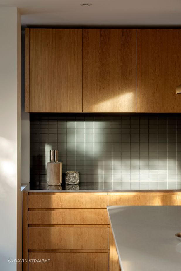 The kitchen receives morning and evening light and is the heart of the open-plan living area.