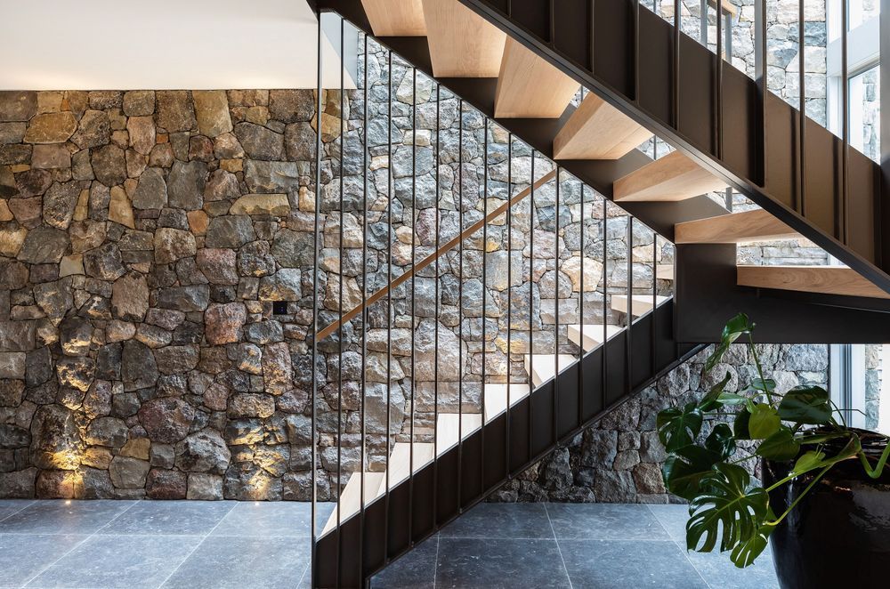 Natural light accentuates the texture of the stone wall.