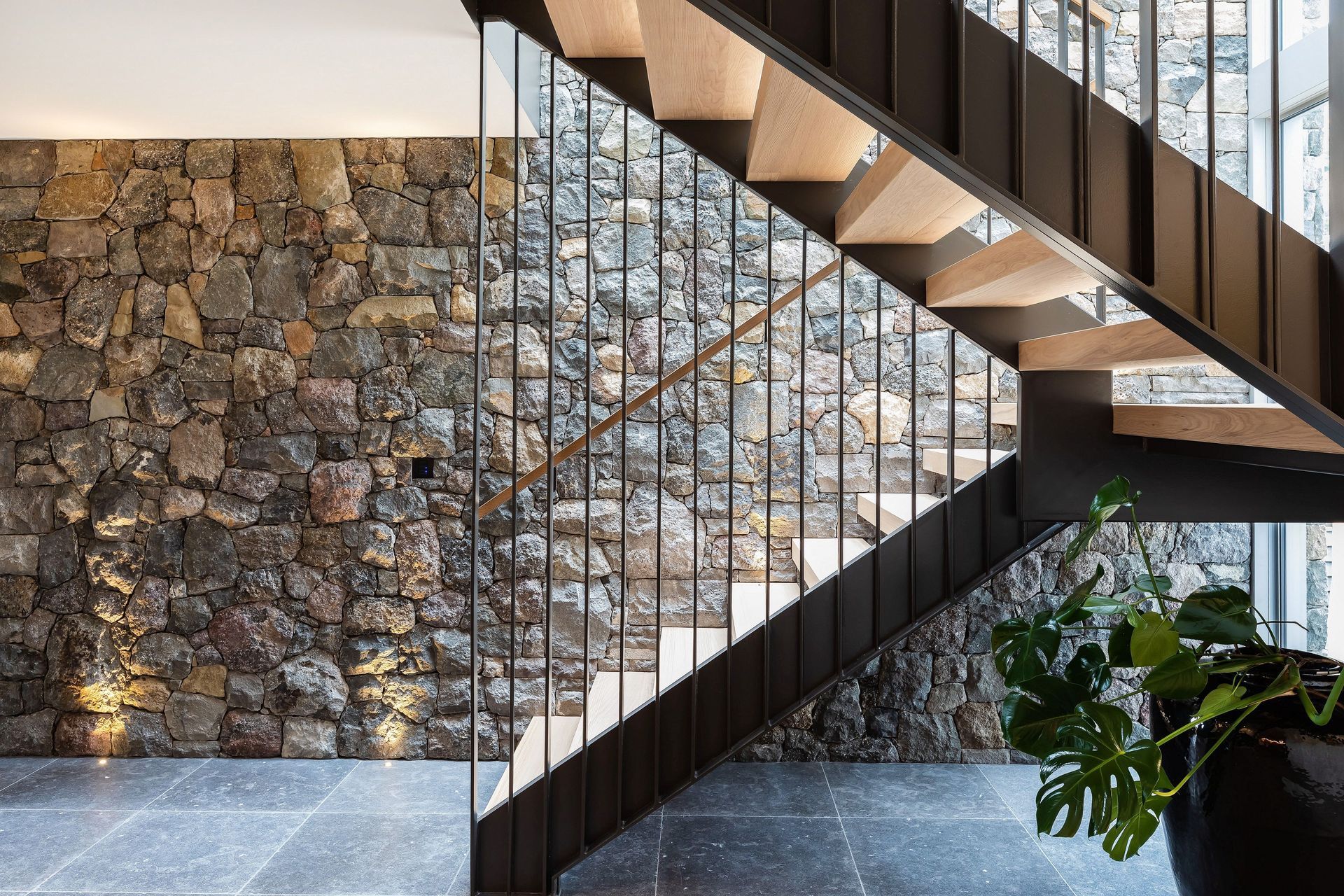Natural light accentuates the texture of the stone wall.