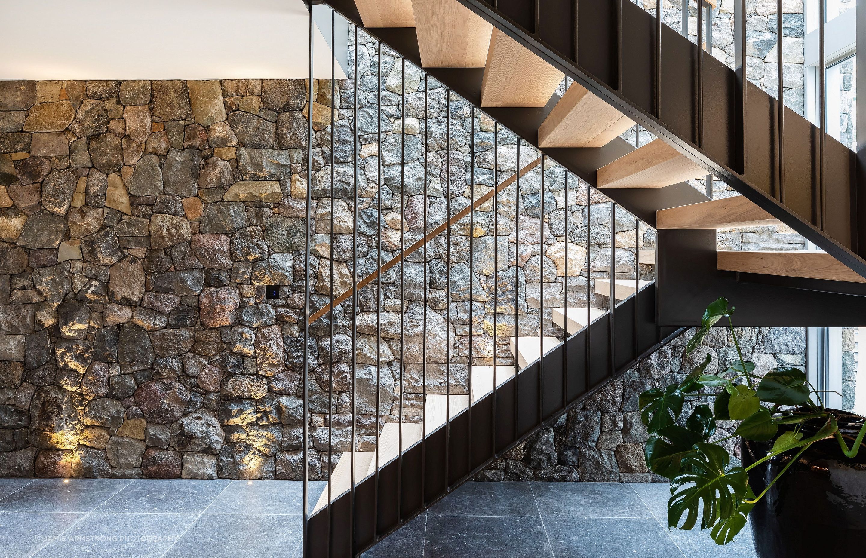 Natural light accentuates the texture of the stone wall.