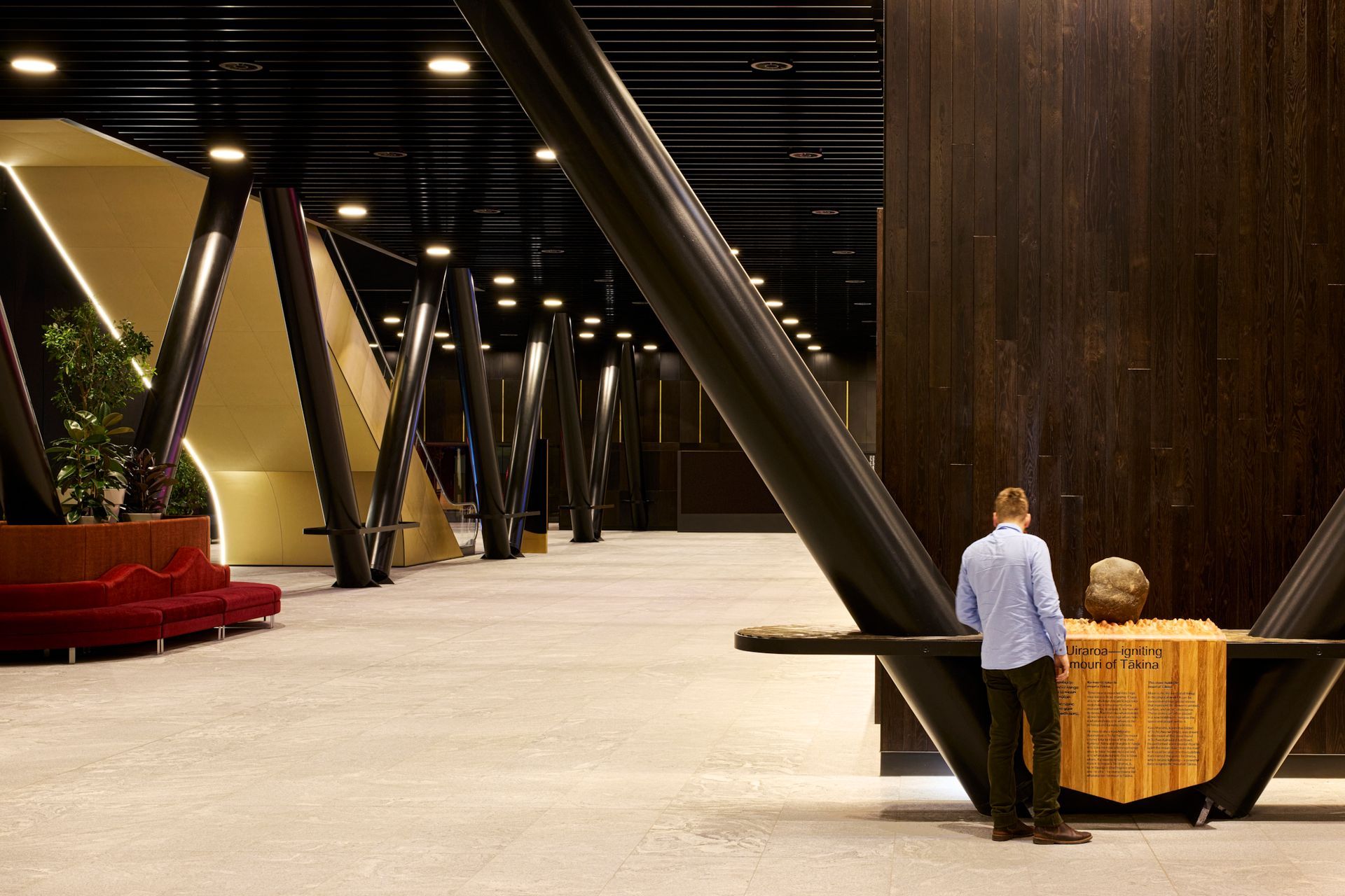 The mouri stone, sitting on hand-carved timber that's mounted for display.