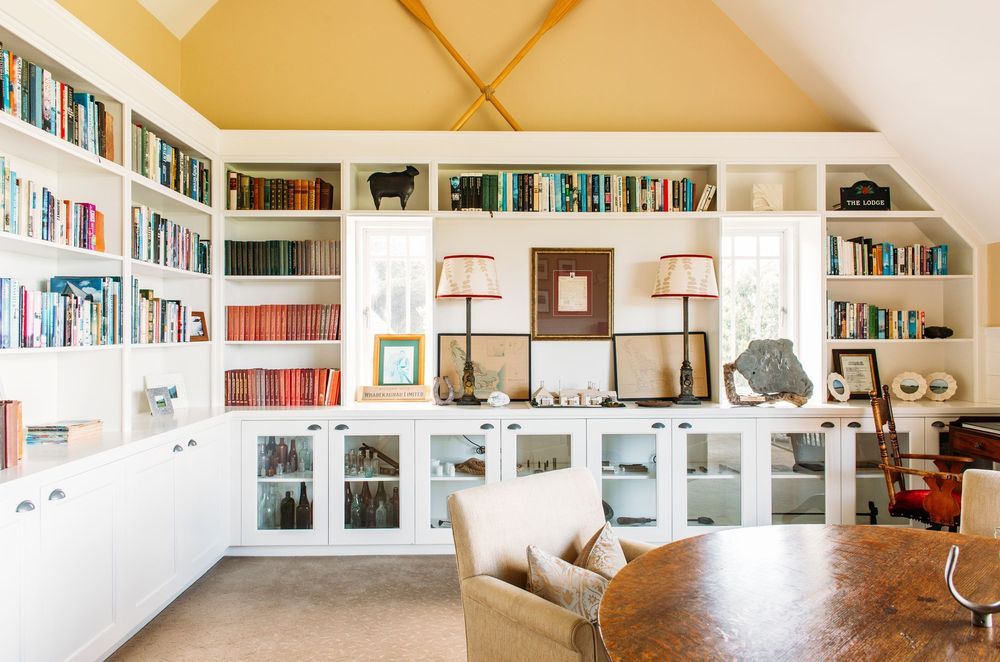 The library is decorated with warm colours to counteract the unusual light in the area thanks to the wide outlooks of sea and sky, says Nikki. “It's a nice little space with a fireplace where you can tuck yourself away.”