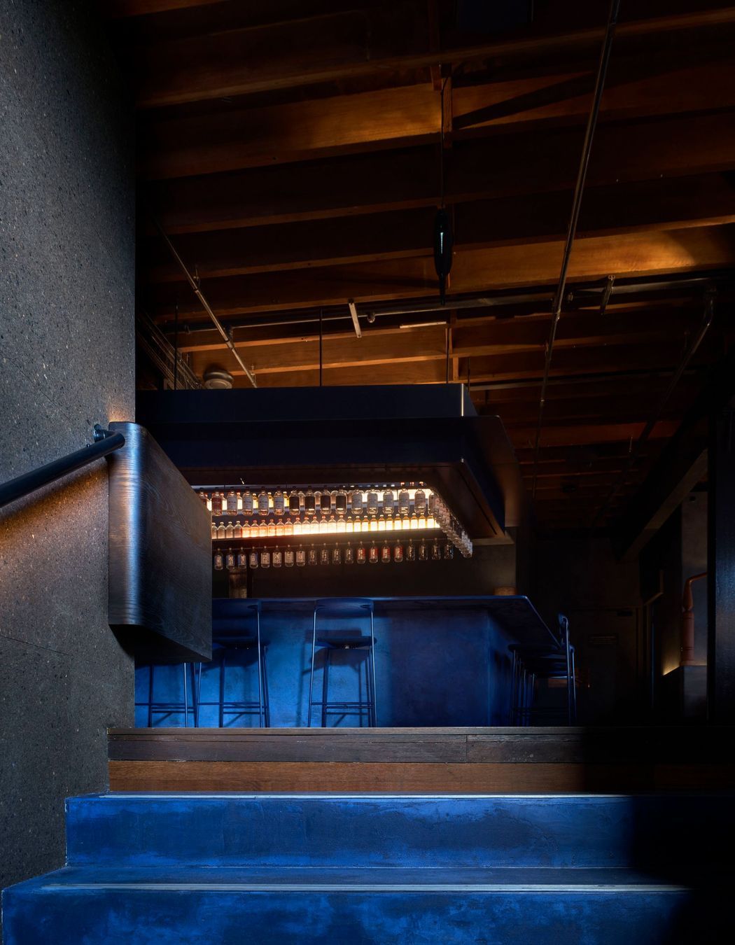 Juniper berry blue stairs lead the way to the Gin Lab and Eileen's Bar.