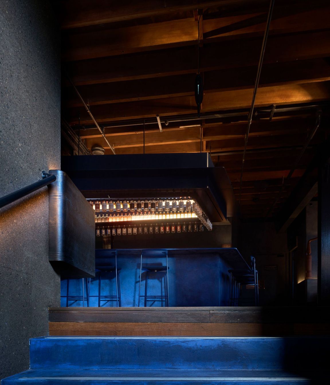 Juniper berry blue stairs lead the way to the Gin Lab and Eileen's Bar.