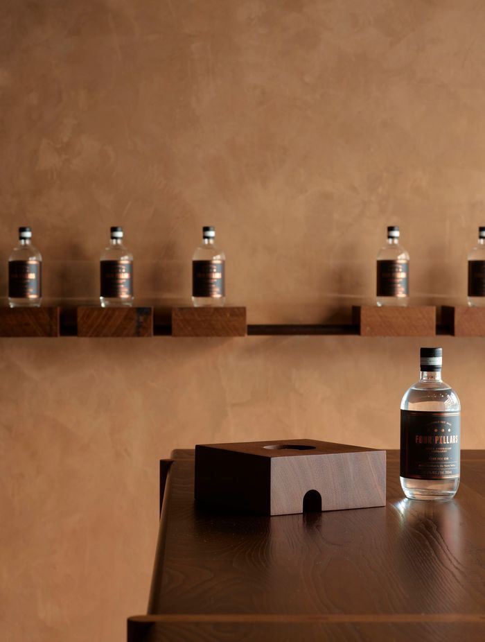 Grooved solid timber blocks with a range of gin bottles can be removed from their metal rail base; instantly converting the store to a cellar door.