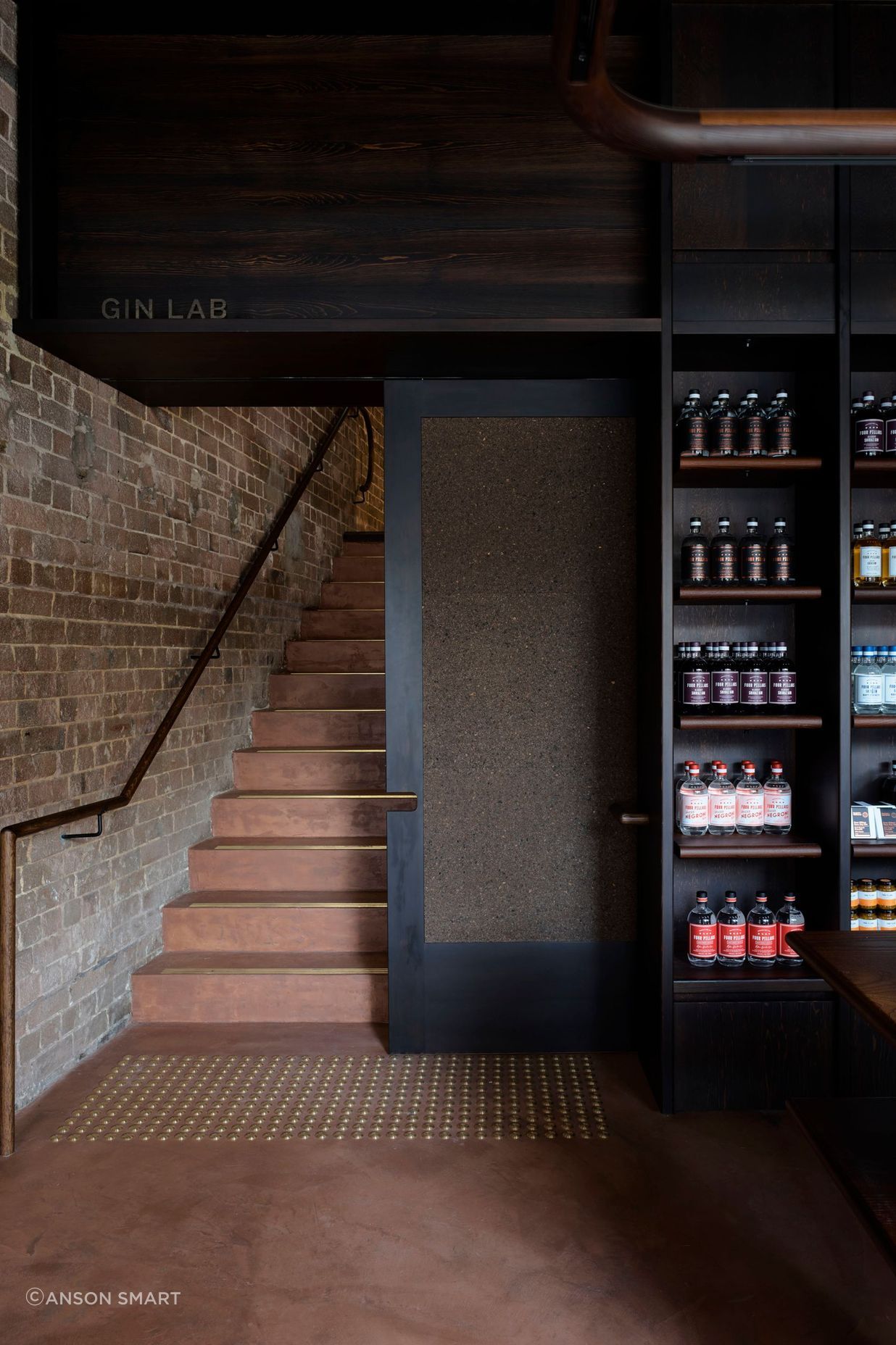 Micro-cement rendered walls and floors with a Pandomo finish add a rustic vibe with a nod to the Four Pillars’ copper-toned logo.
