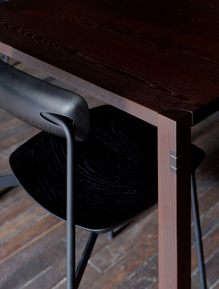 Black-stained Sia timber chairs pair with cambia ash tables.