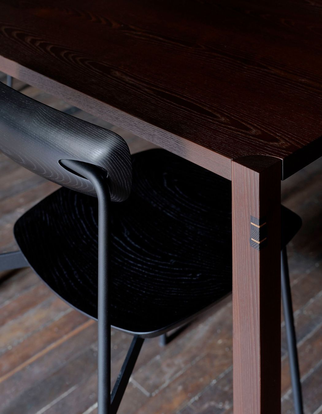 Black-stained Sia timber chairs pair with cambia ash tables.