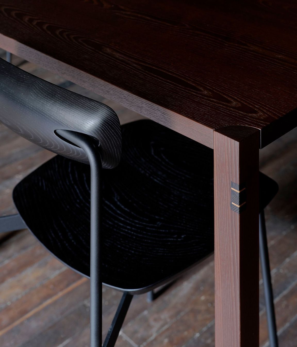 Black-stained Sia timber chairs pair with cambia ash tables.