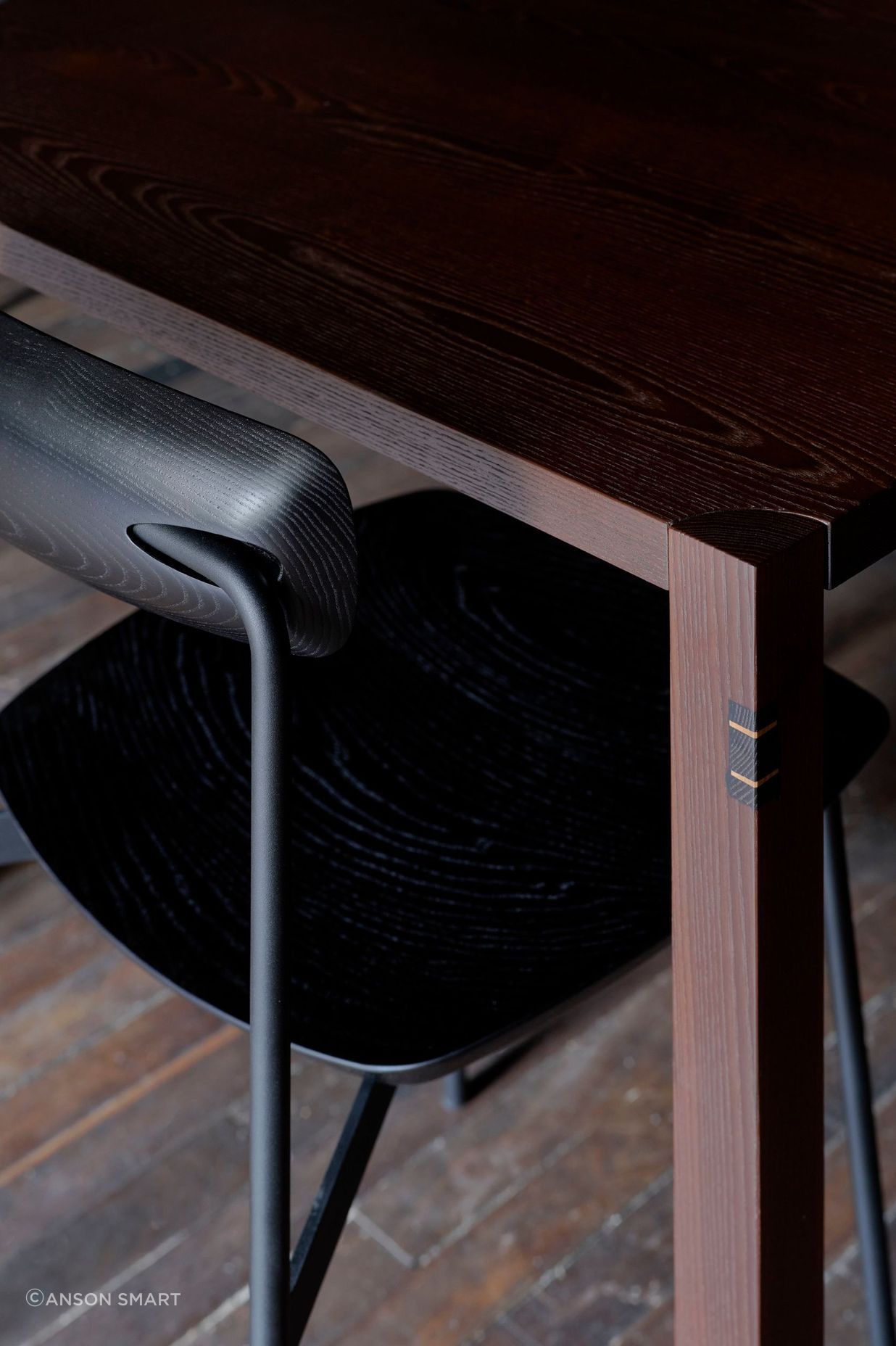 Black-stained Sia timber chairs pair with cambia ash tables.