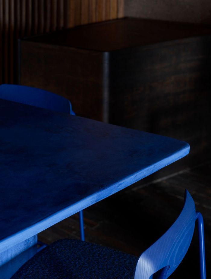 Custom juniper berry blue powder-coated bar stools with dotted Kvadrat/Raf Simons fabric and stained blue timber backrests.