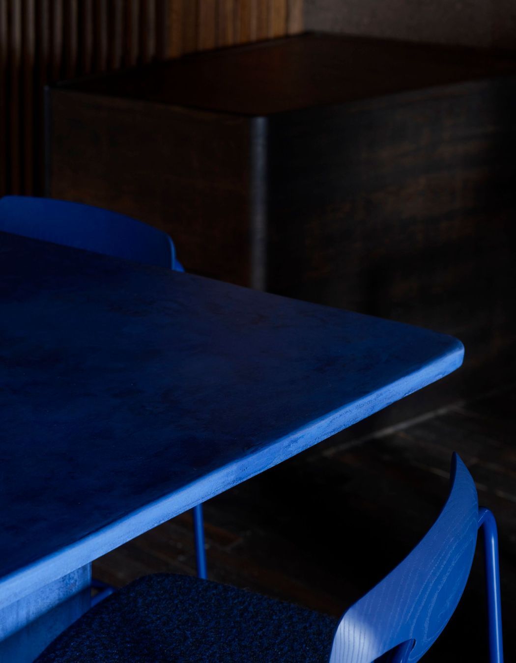 Custom juniper berry blue powder-coated bar stools with dotted Kvadrat/Raf Simons fabric and stained blue timber backrests.