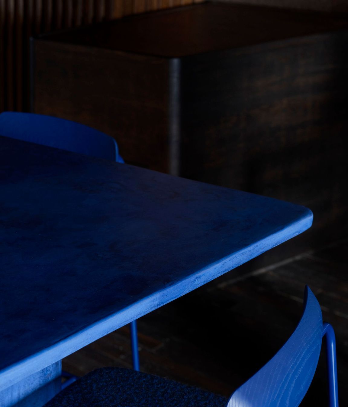Custom juniper berry blue powder-coated bar stools with dotted Kvadrat/Raf Simons fabric and stained blue timber backrests.