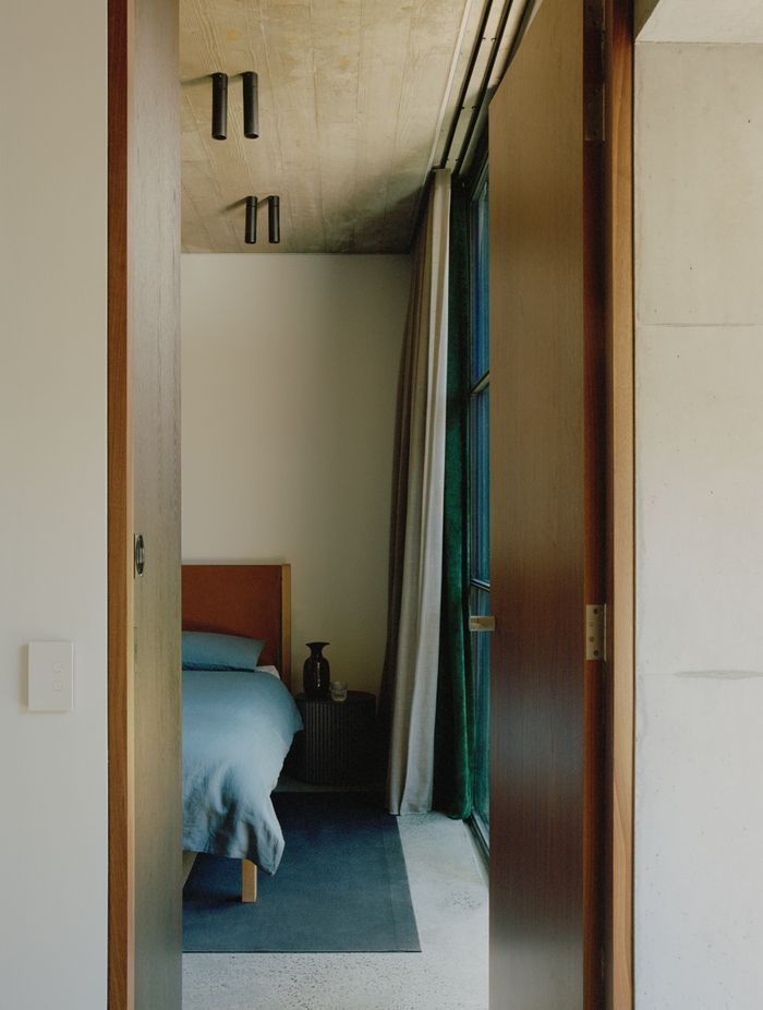 A peek of a soothing and textural bedroom in the tower.