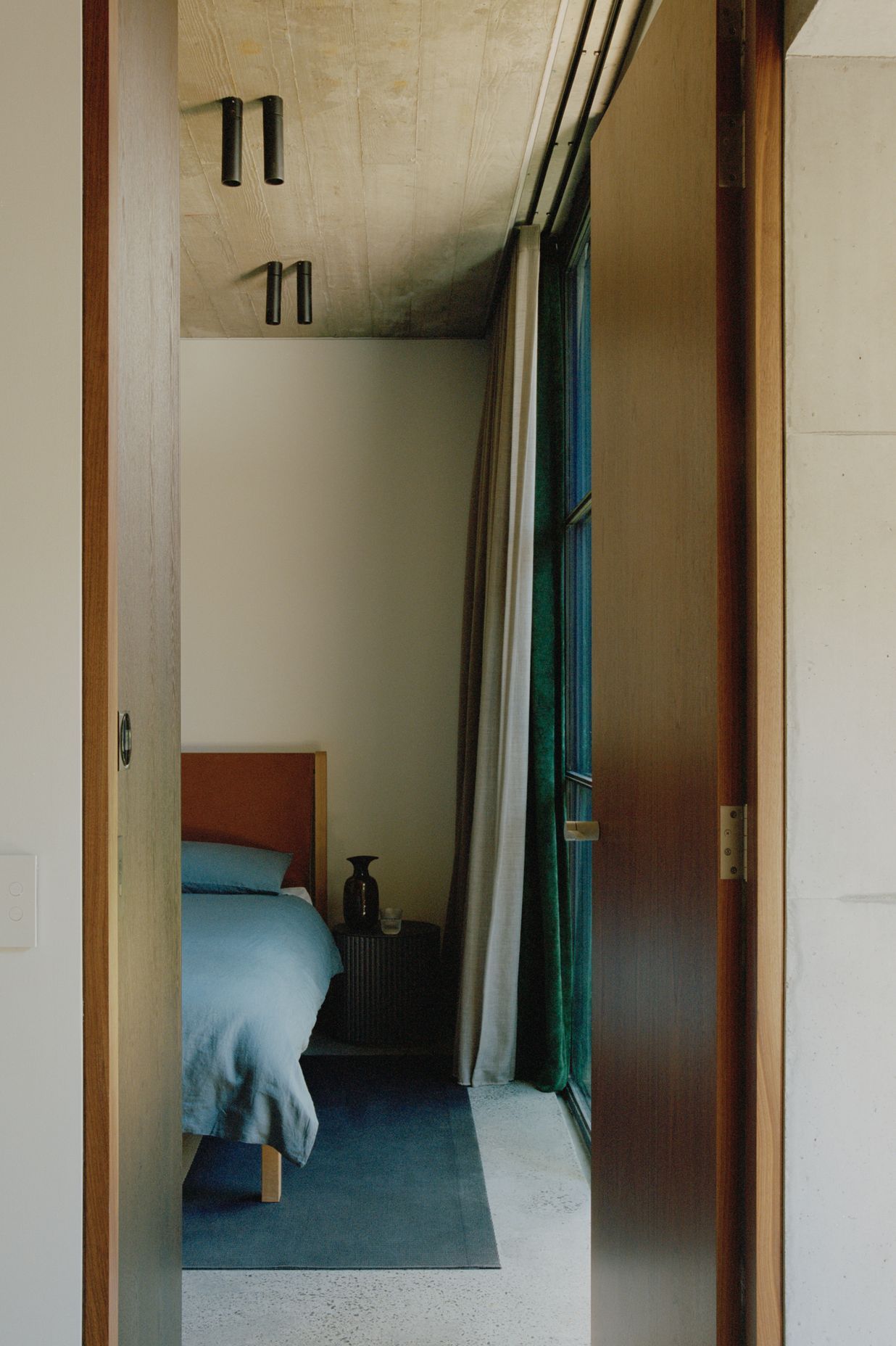 A peek of a soothing and textural bedroom in the tower.