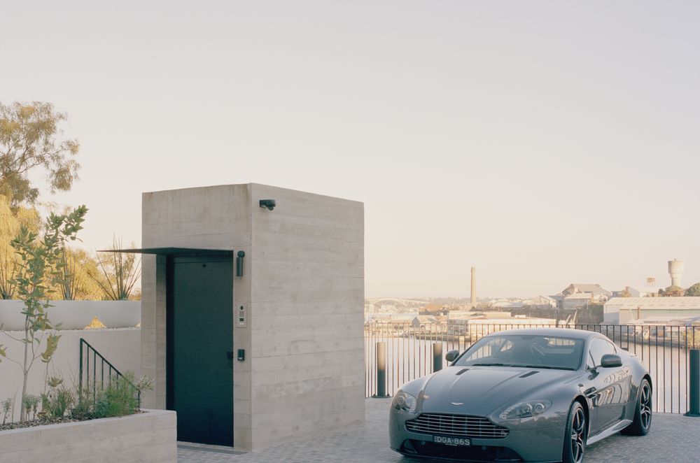 The lift protruding from the concrete form at street level is the only indication of the jaw-dropping structure below.