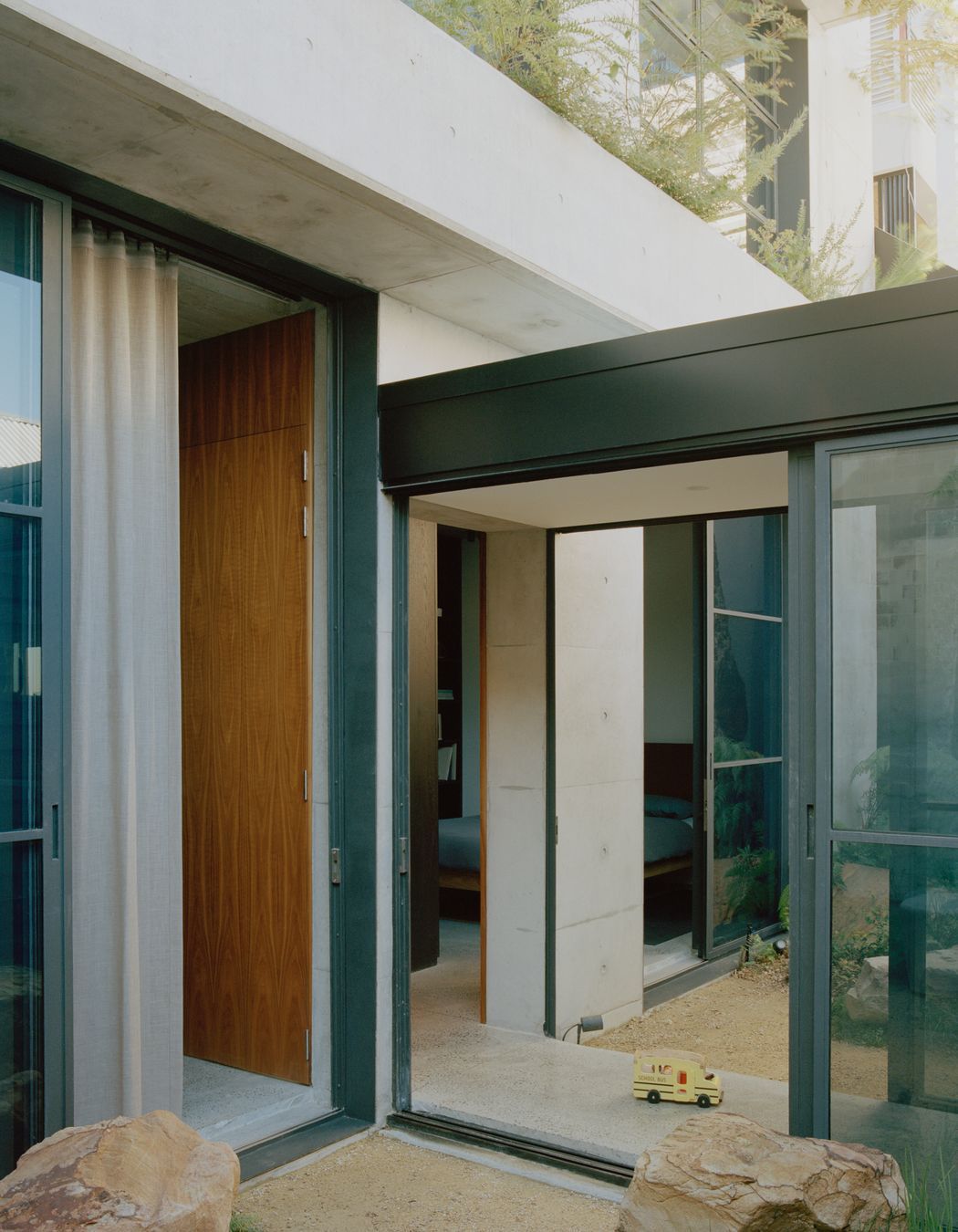 The glazed hallway passes through a courtyard on either side.