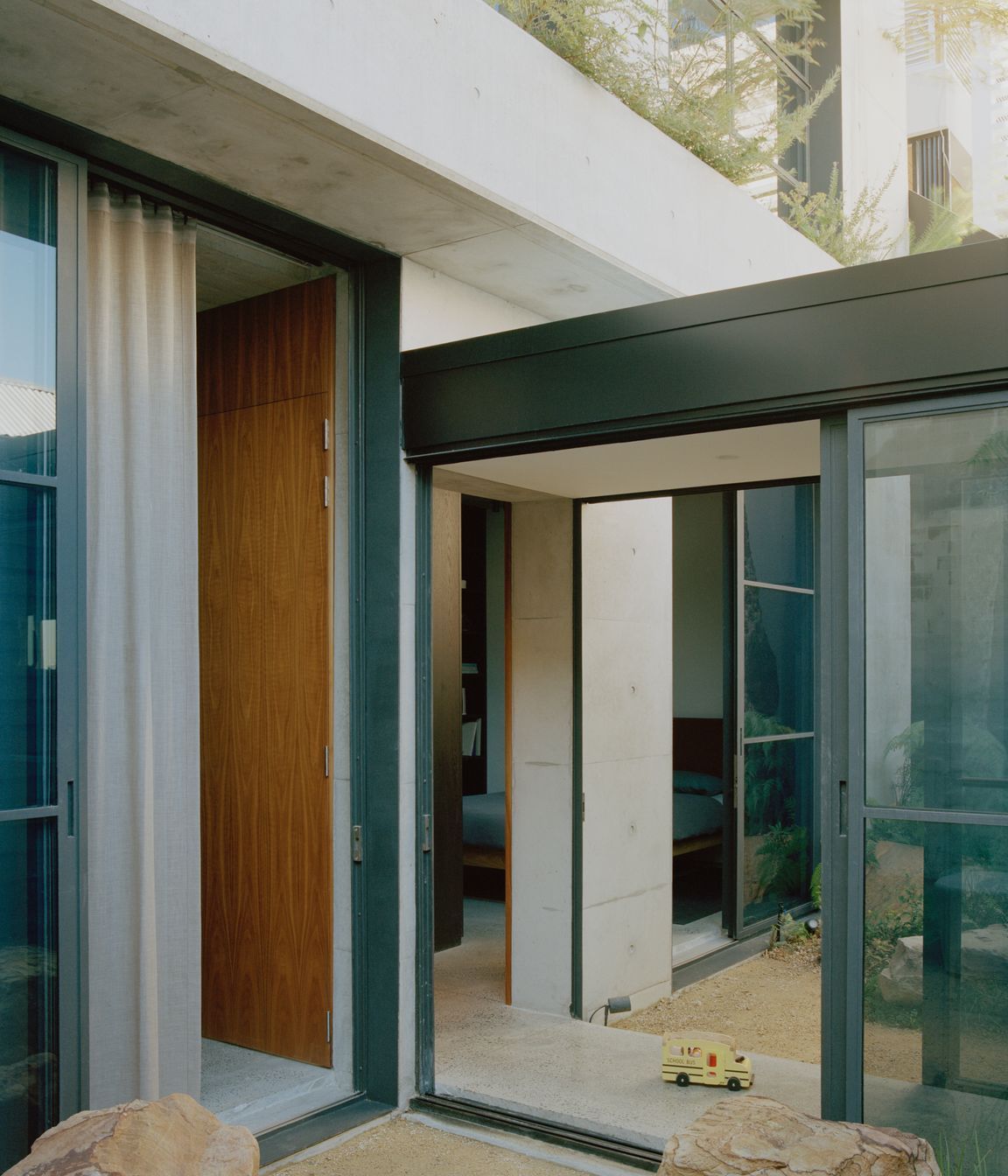 The glazed hallway passes through a courtyard on either side.