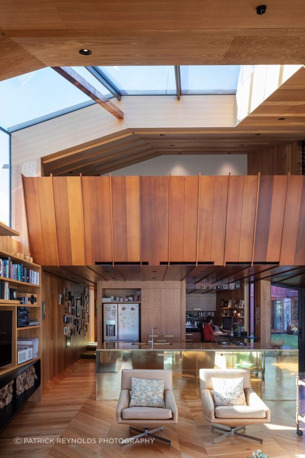 “We wanted something strong within that main living space,” says Brad of the brass kitchen island. “We do the whole thing, the whole process. We design all the cabinetry and joinery, anything that’s built. We drew all the kitchen cabinetry, the built-in furniture, the bench seating in the living room. It’s something we like to do. The home isn’t finished at the shell.”