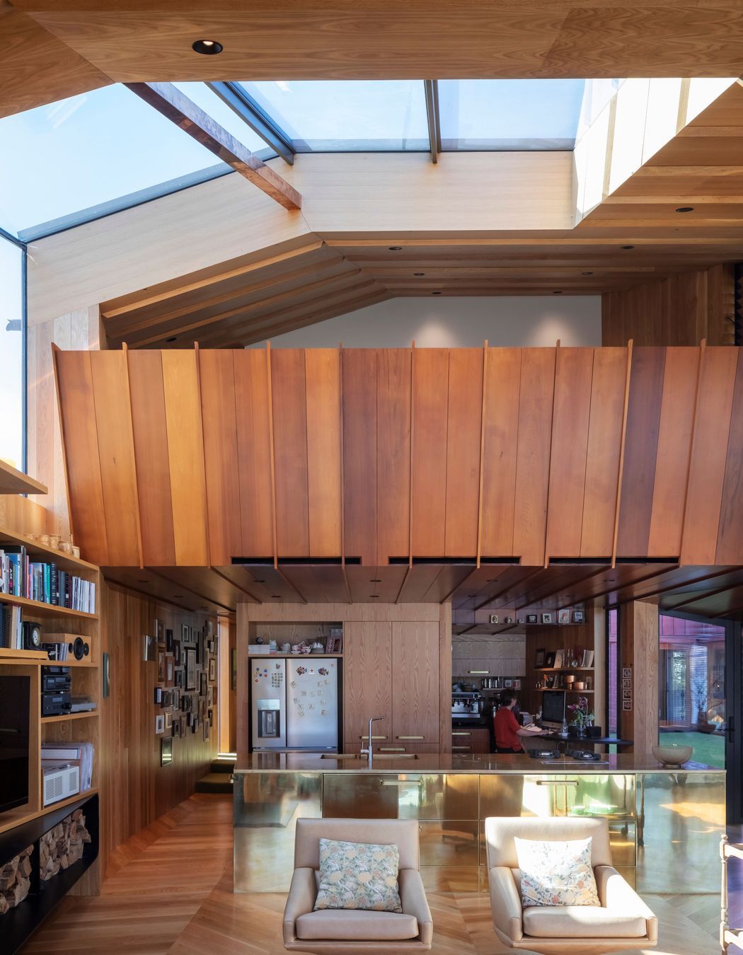 “We wanted something strong within that main living space,” says Brad of the brass kitchen island. “We do the whole thing, the whole process. We design all the cabinetry and joinery, anything that’s built. We drew all the kitchen cabinetry, the built-in furniture, the bench seating in the living room. It’s something we like to do. The home isn’t finished at the shell.”