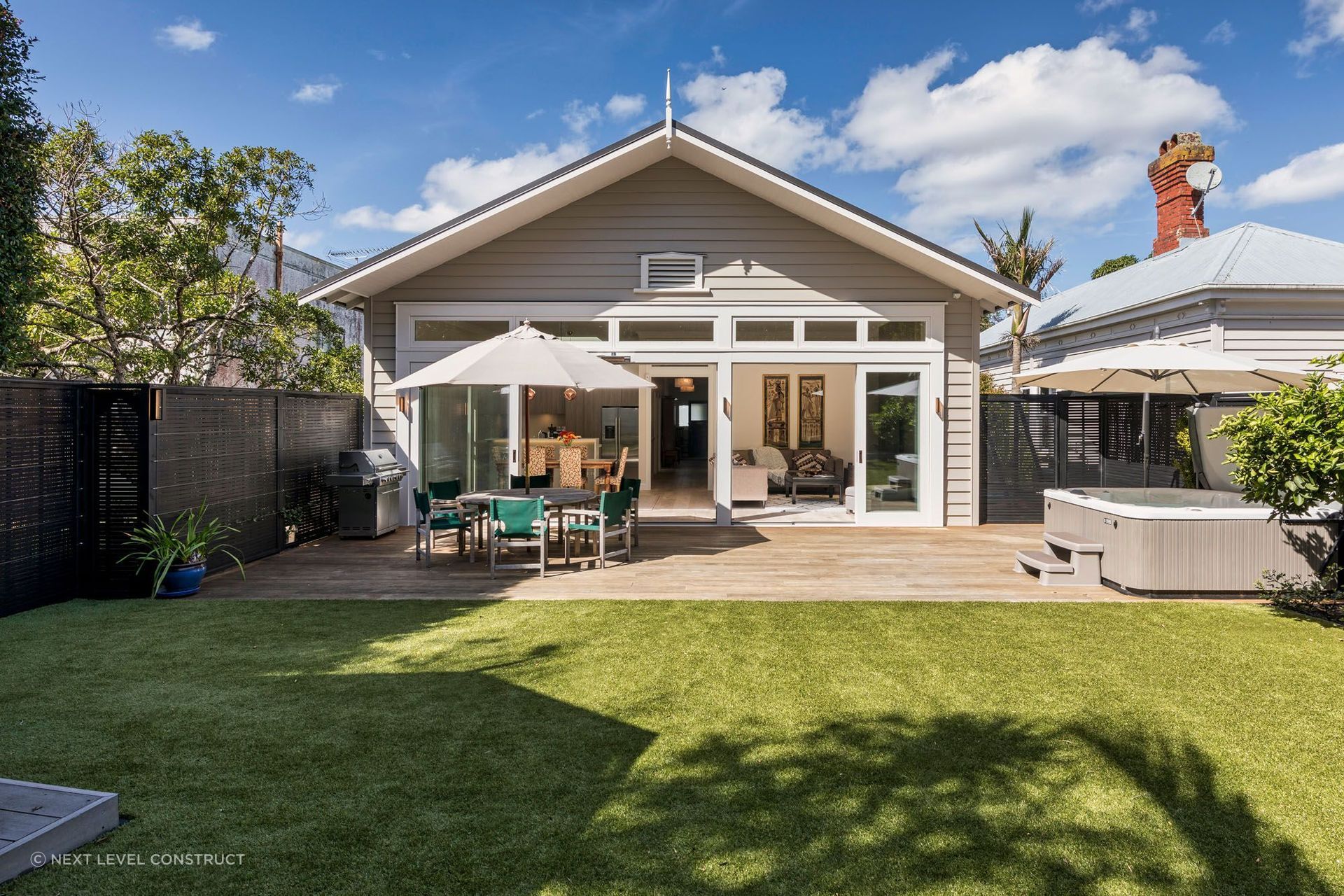 The rear extension complements the villa's original architectural style.