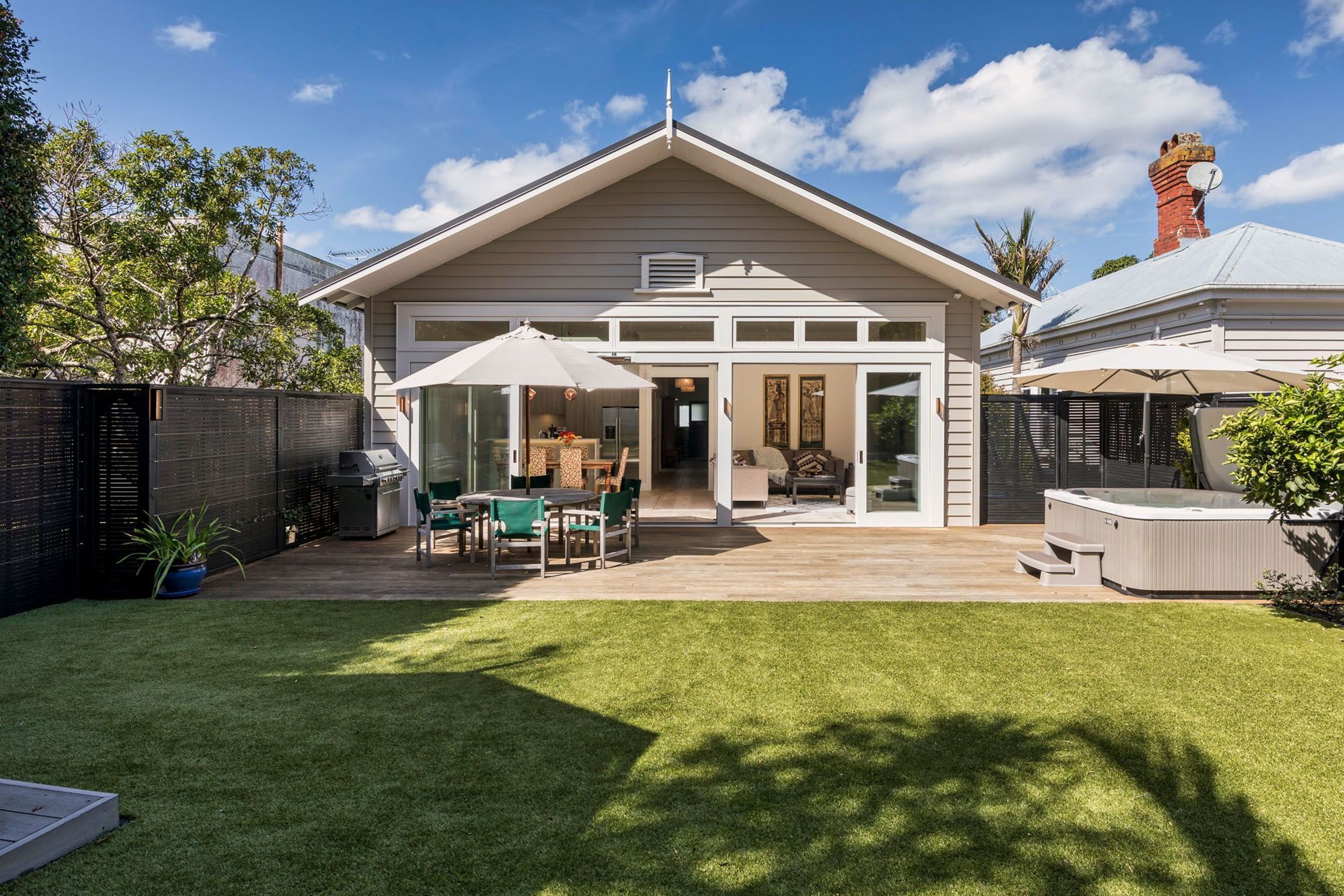 The rear extension complements the villa's original architectural style.