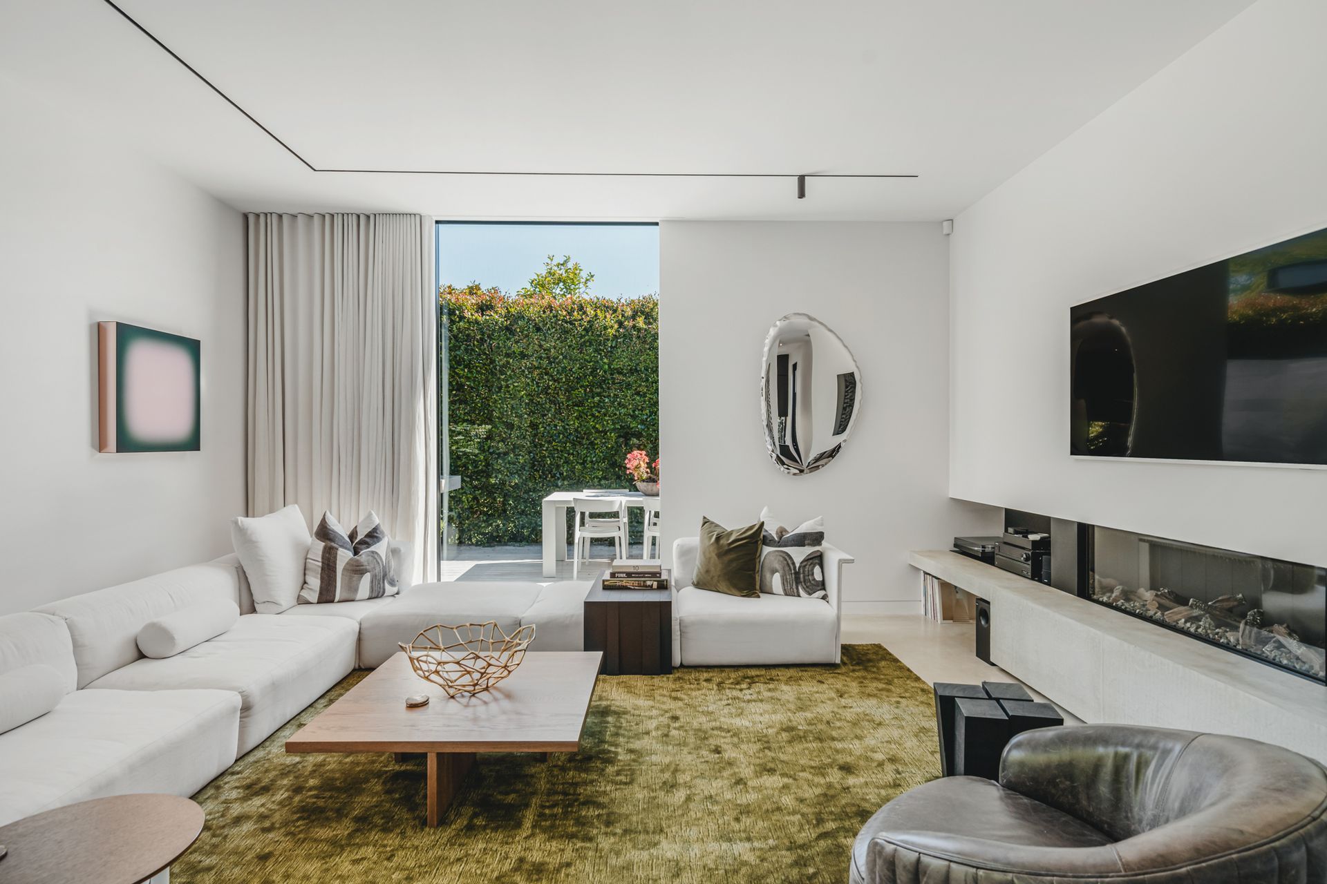 A modern lounge with gas fireplace is part of the new addition, offering a cosy second space.