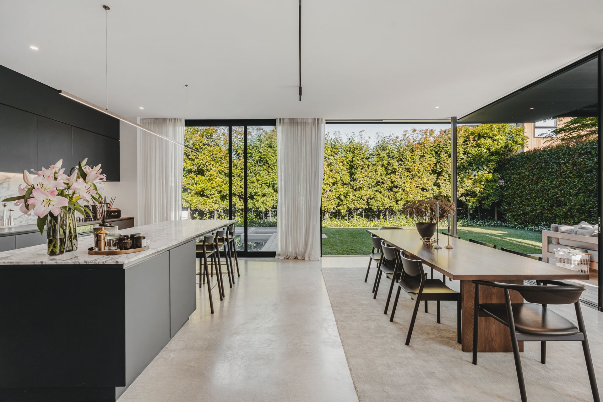 The view of the outdoor living space and pool creates a sense of being at a retreat.