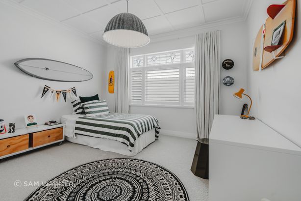 A boy's bedroom keeps the backdrop simple and the furnishings bold.