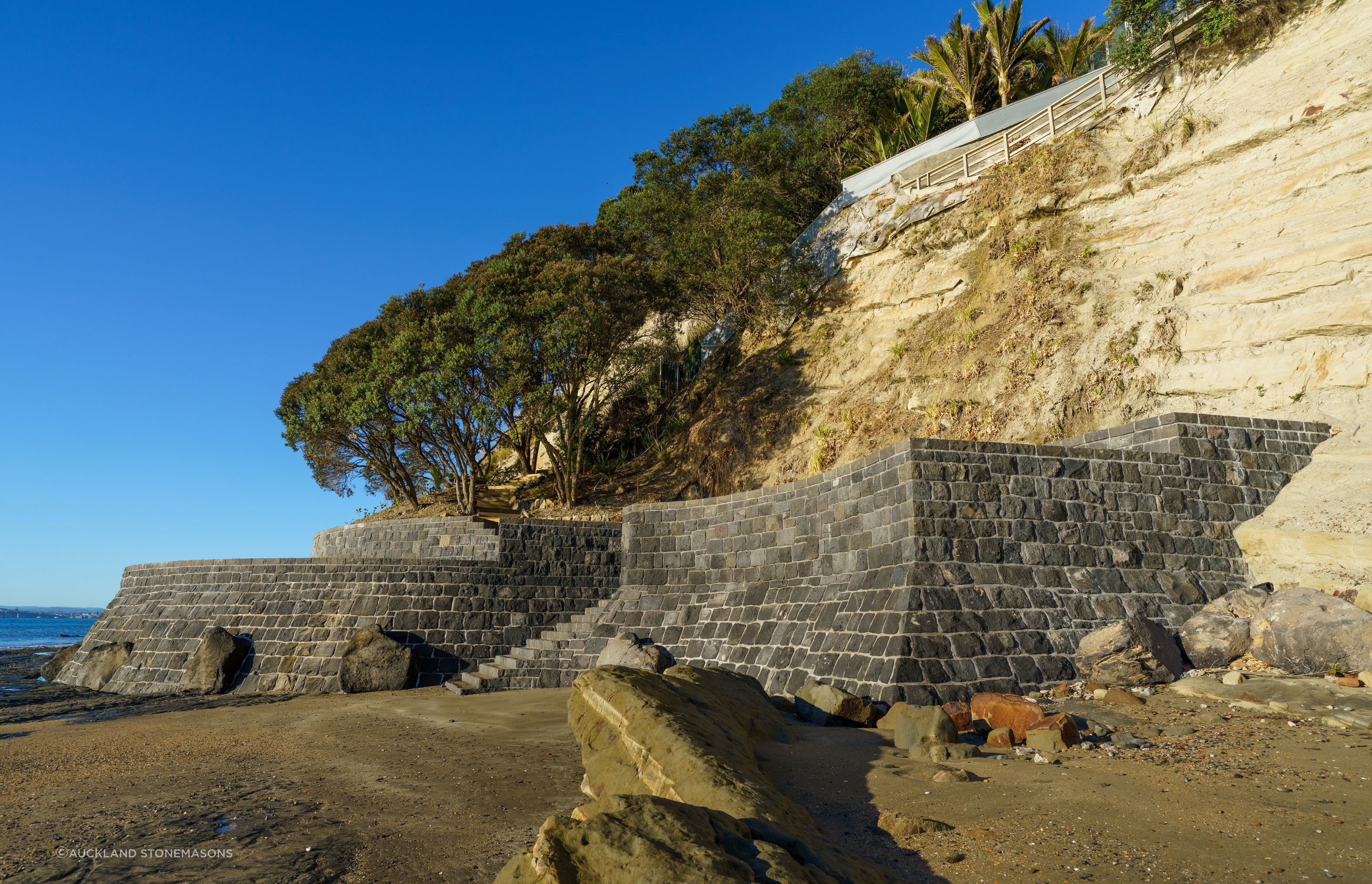 The client was concerned about protecting the pohutukawa trees on his property, engaging Auckland Stonemasons to build a sea wall that would stop them being washed away in the event of a storm.