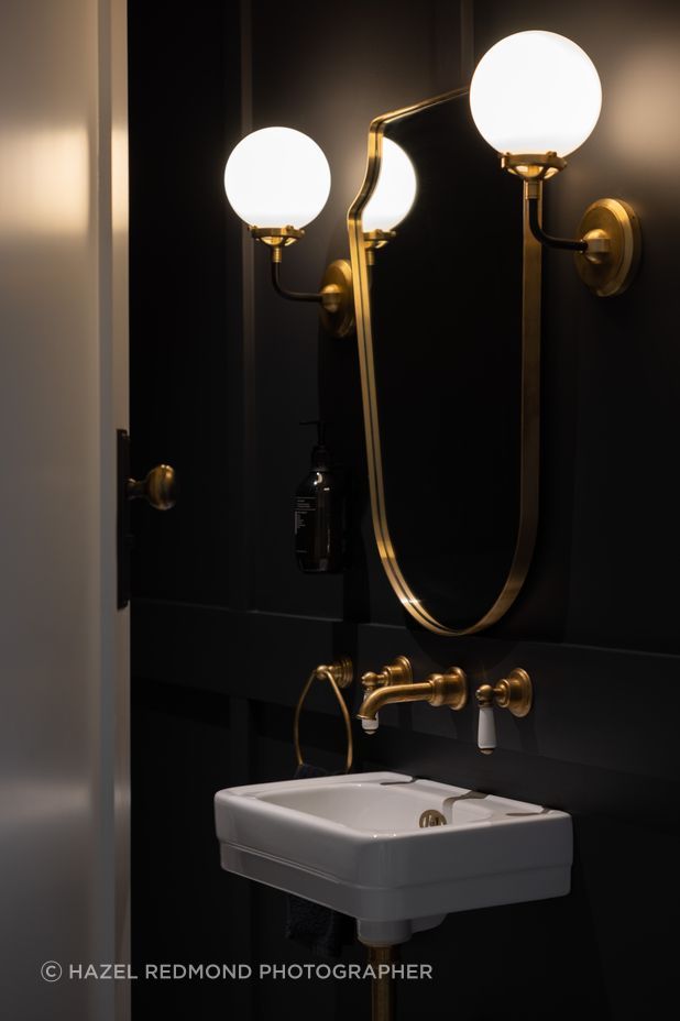 Gold accents add a luxurious feel to the bathrooms.