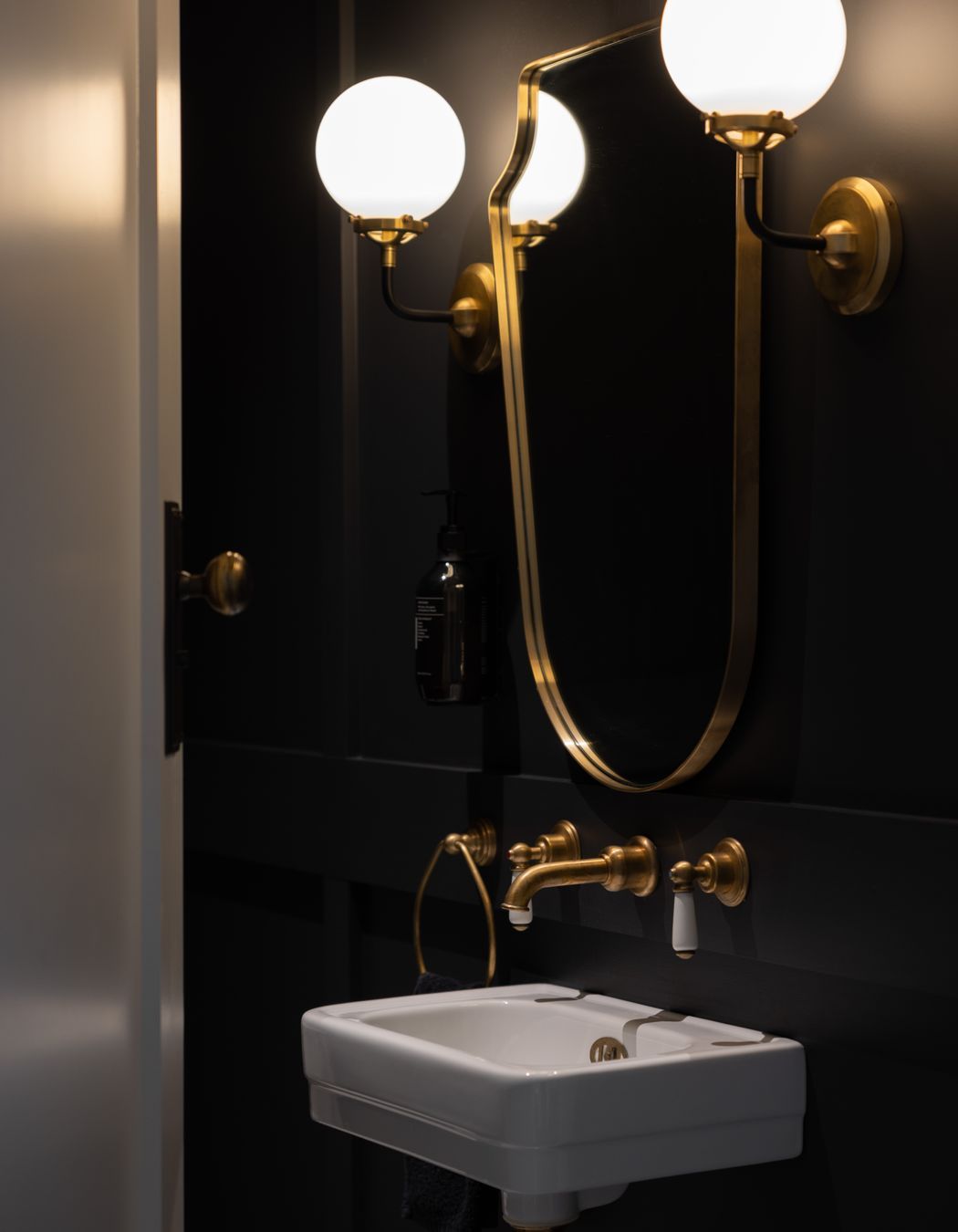 Gold accents add a luxurious feel to the bathrooms.