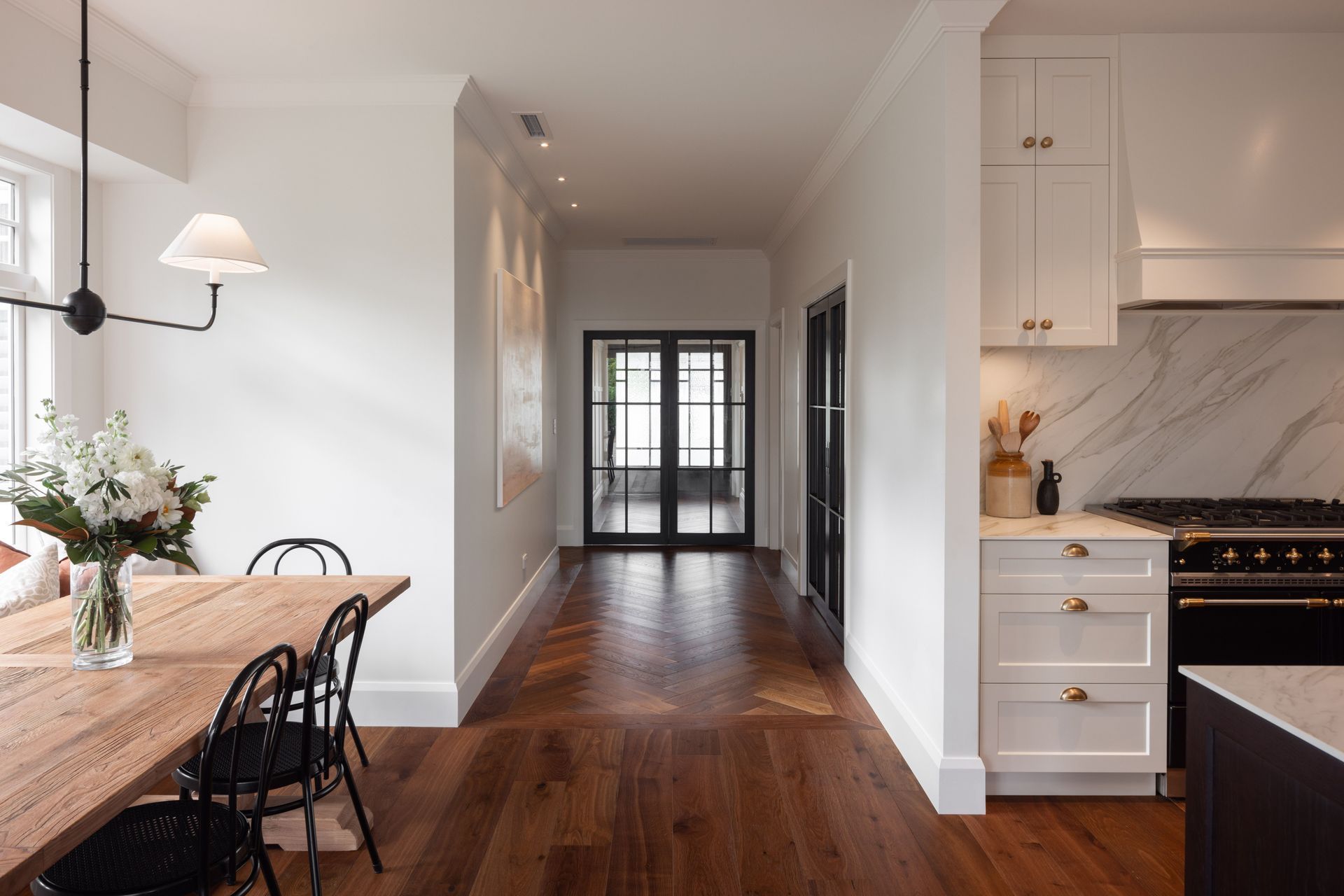 Crittall doors add a touch of industrialism, expertly juxtaposed with the rustic, farmhouse chic styling.