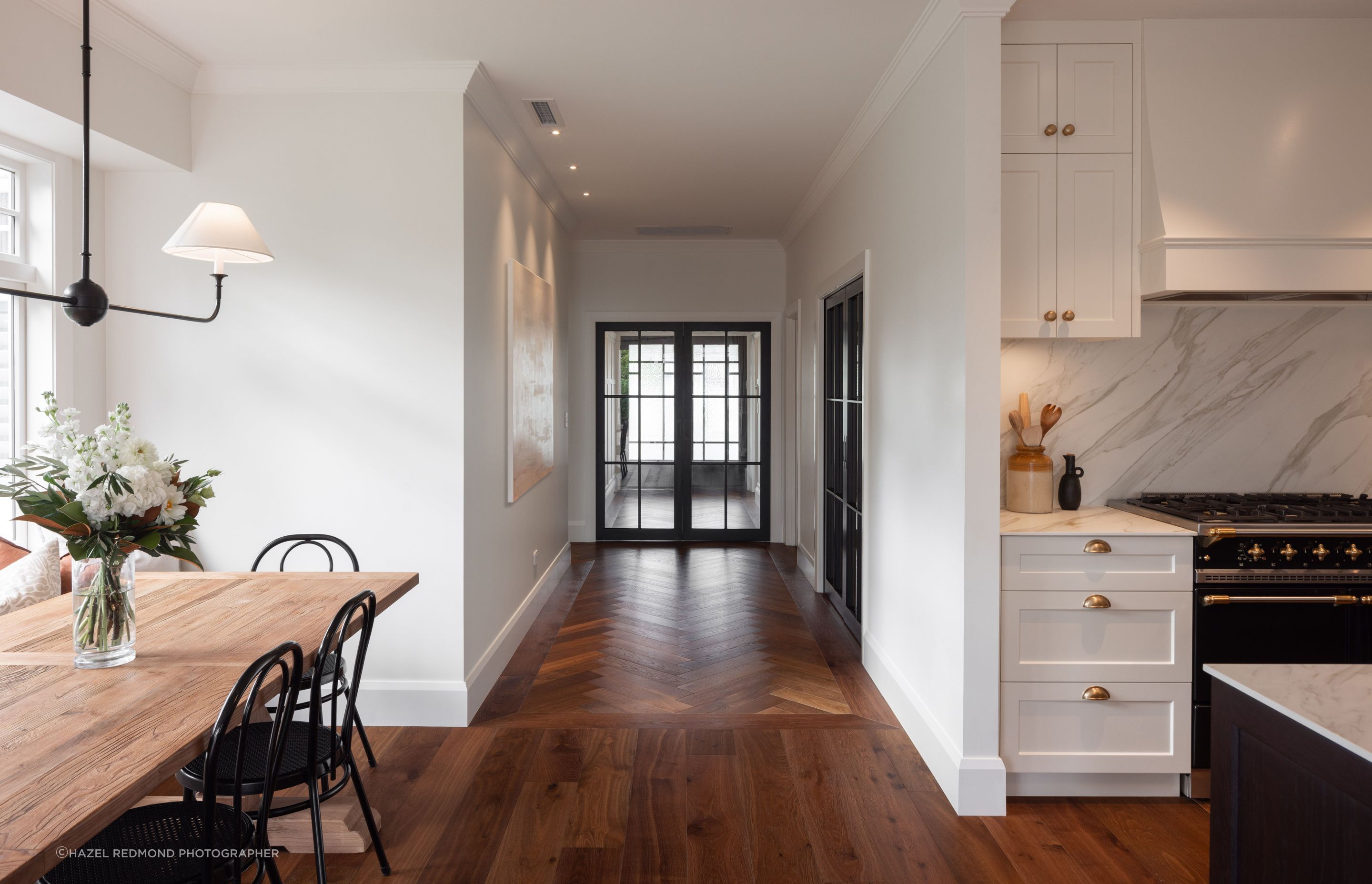 Crittall doors add a touch of industrialism, expertly juxtaposed with the rustic, farmhouse chic styling.