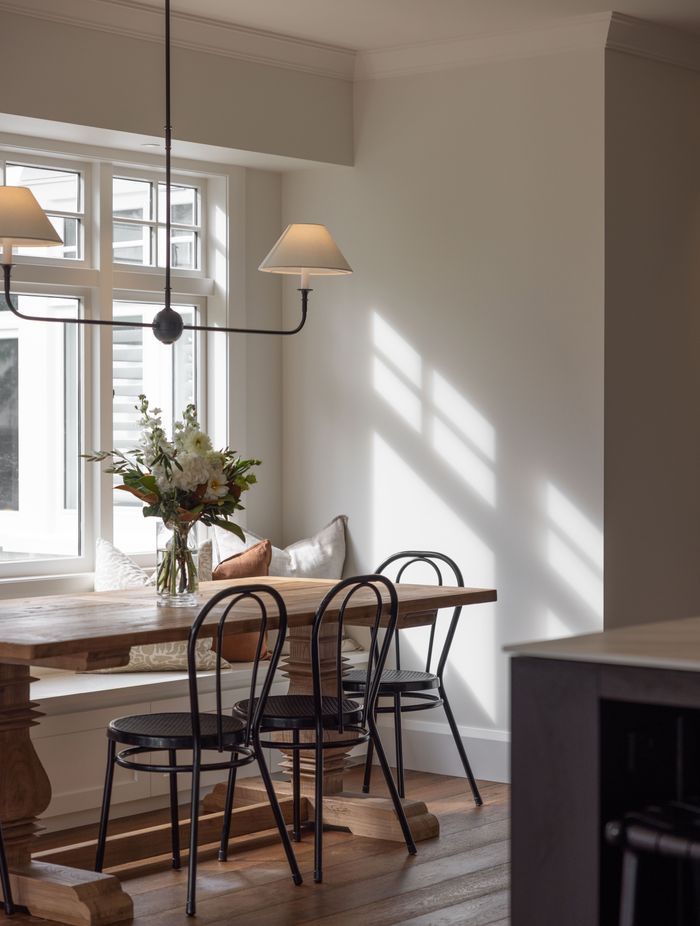 A built in bench seat adds a farmhouse flair to the dining area.