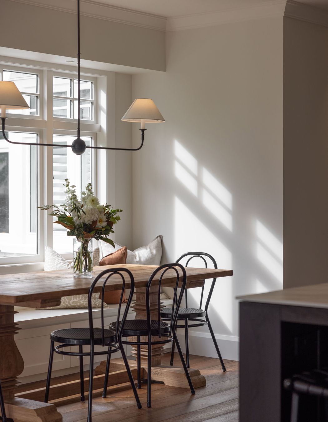 A built in bench seat adds a farmhouse flair to the dining area.