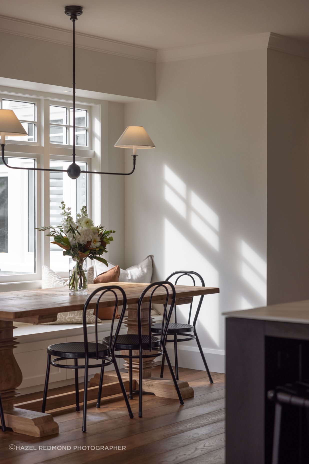 A built in bench seat adds a farmhouse flair to the dining area.