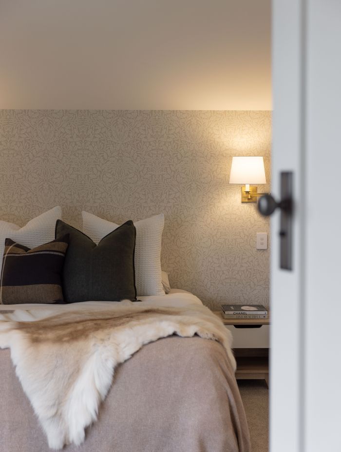 The bedrooms have a hotel-like feel with soft, ambient lighting and elegant wallpaper.