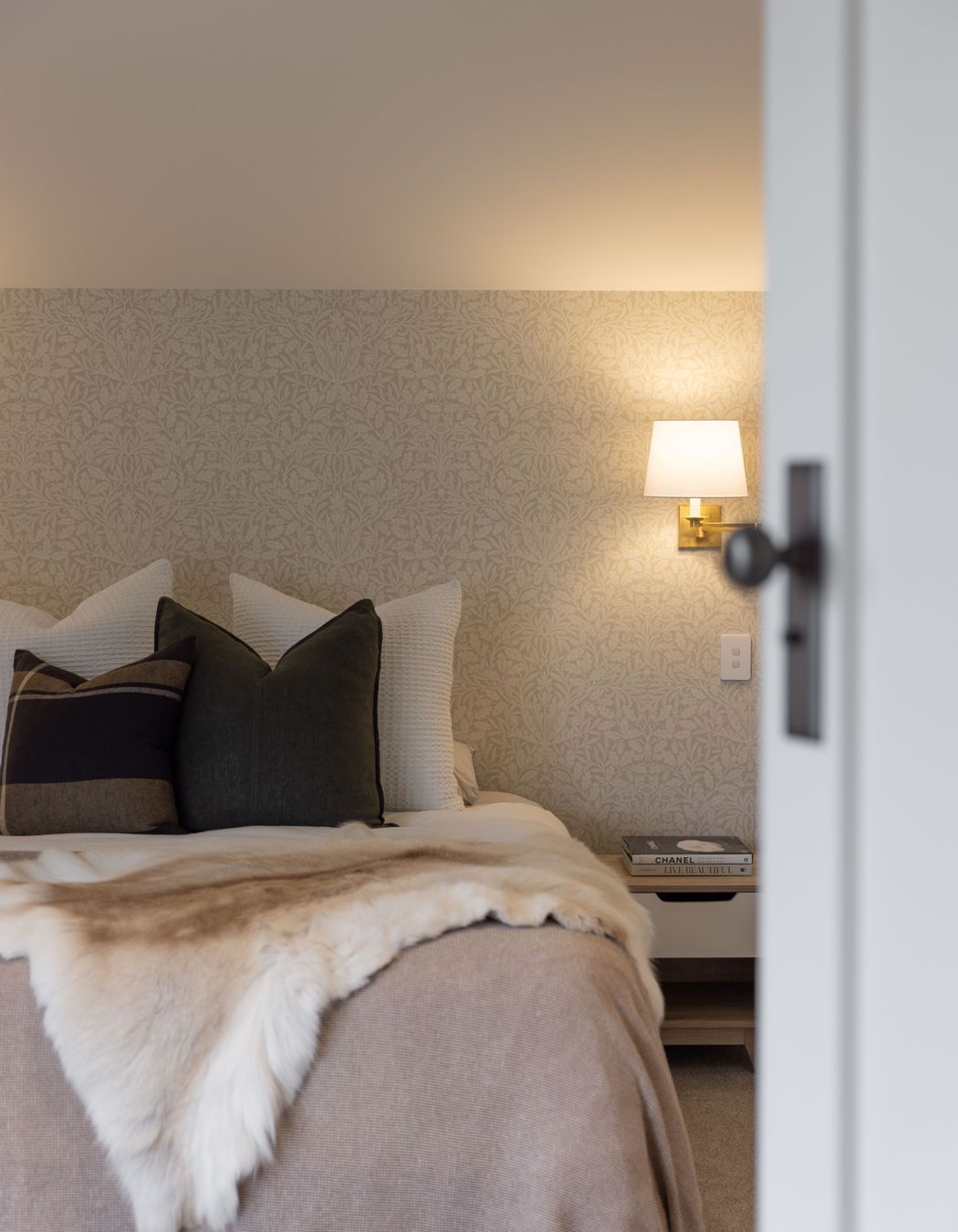 The bedrooms have a hotel-like feel with soft, ambient lighting and elegant wallpaper.