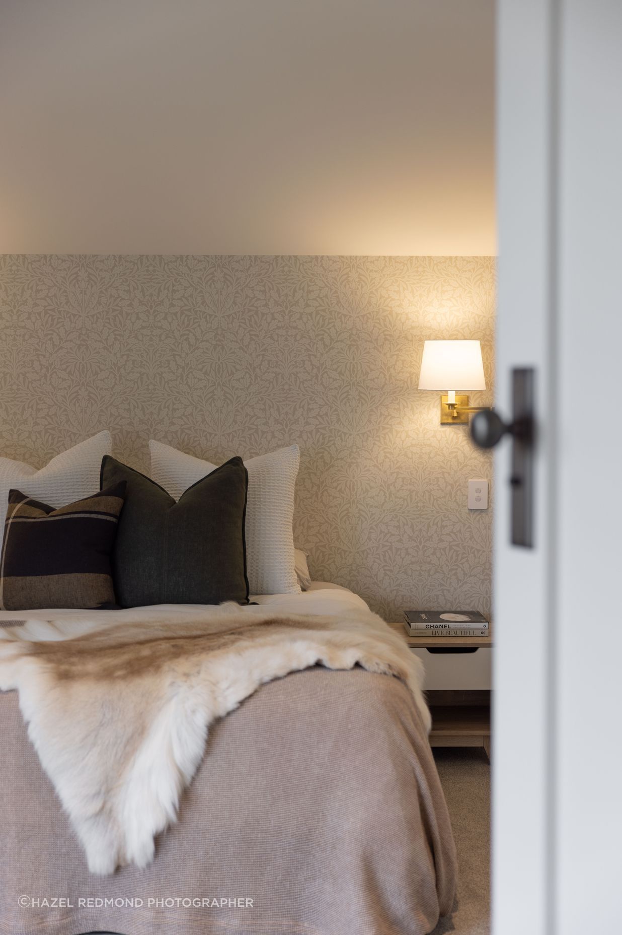 The bedrooms have a hotel-like feel with soft, ambient lighting and elegant wallpaper.