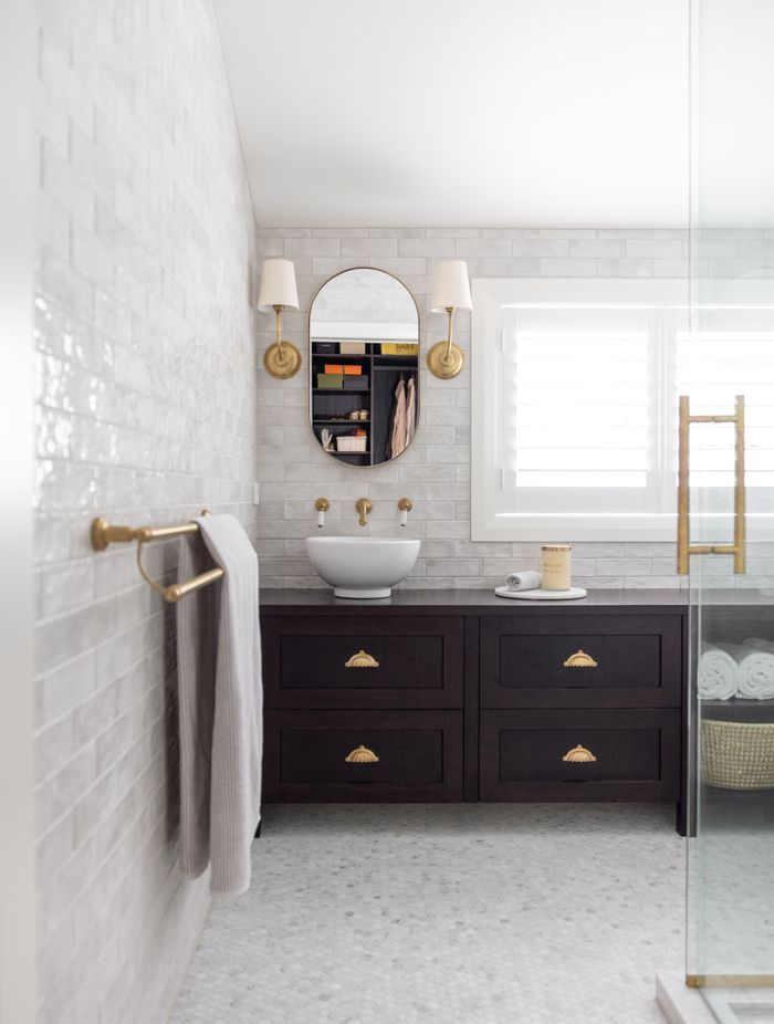 The ensuite feels bright and open, with glossy white subway tiles adding a hint of texture to the walls.