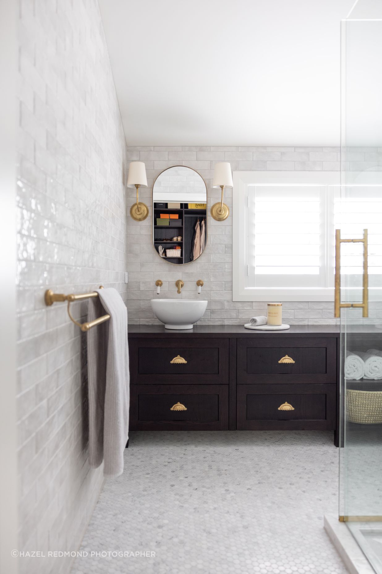 The ensuite feels bright and open, with glossy white subway tiles adding a hint of texture to the walls.