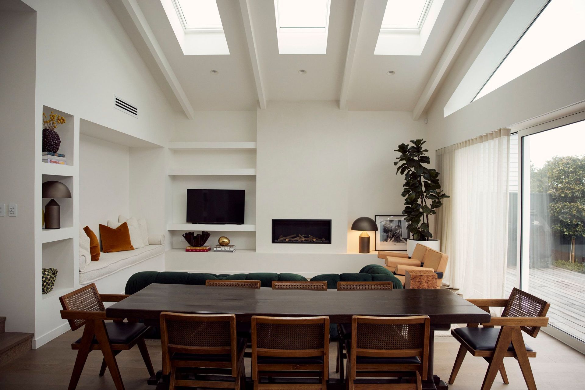 Space was optimised by creating an open-plan cathedral-like room with vaulted ceilings, exposed rafters, and skylights to allow for ample natural light.