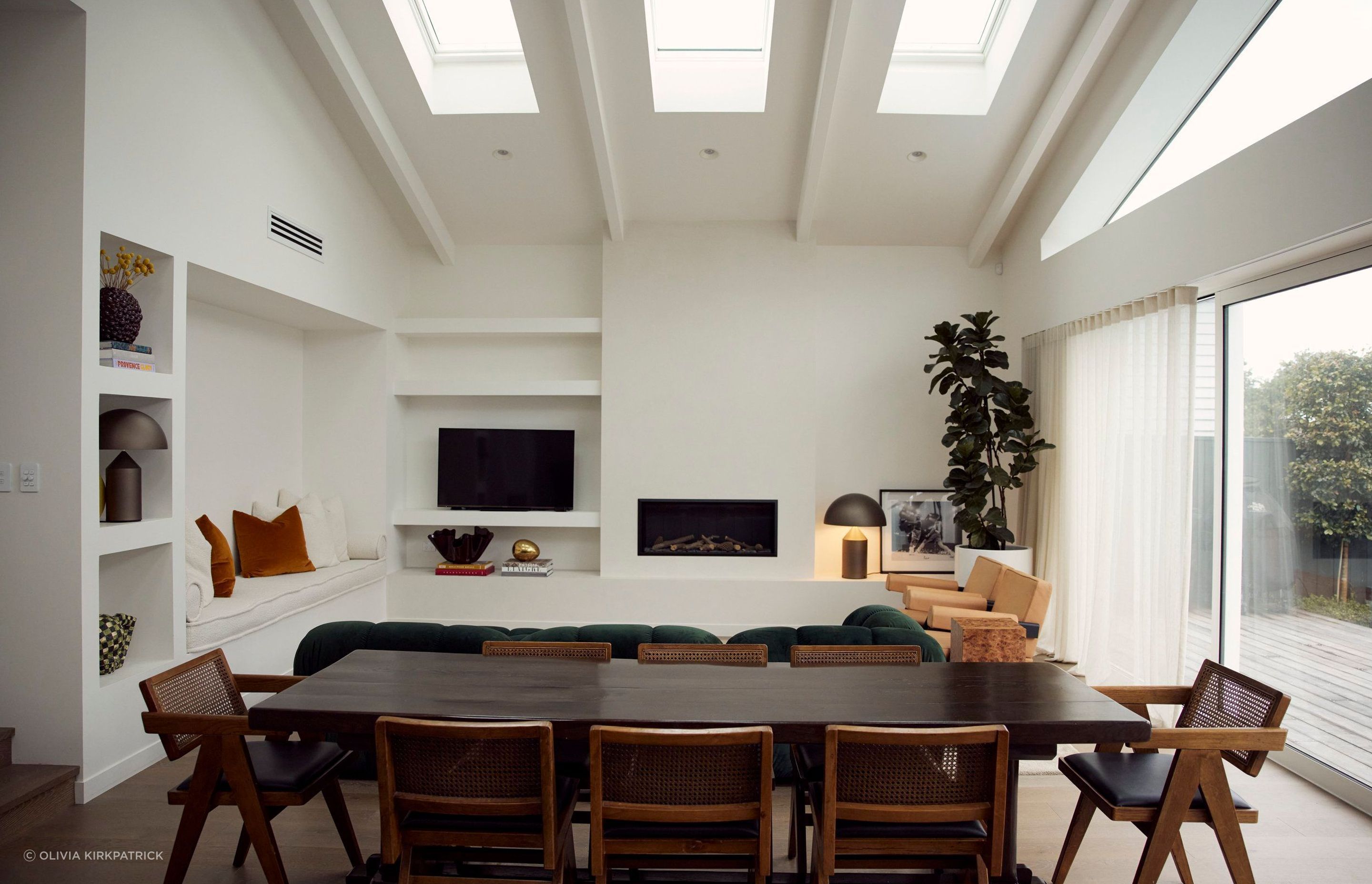 Space was optimised by creating an open-plan cathedral-like room with vaulted ceilings, exposed rafters, and skylights to allow for ample natural light.