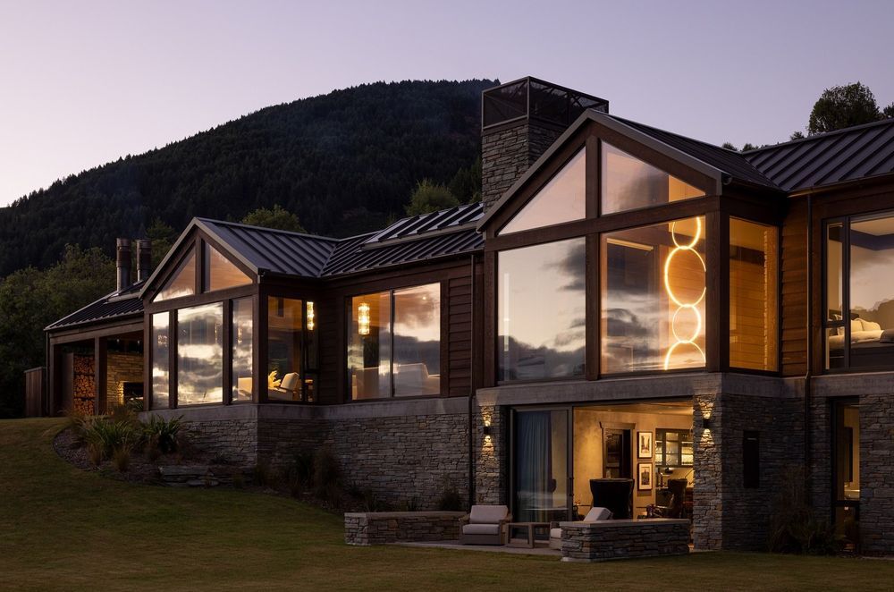 The gable forms intersect each other, in a cruciform pattern, with the home laid across the hillside, meaning it takes the light in from the rear (north) and the aouth views of the lake.