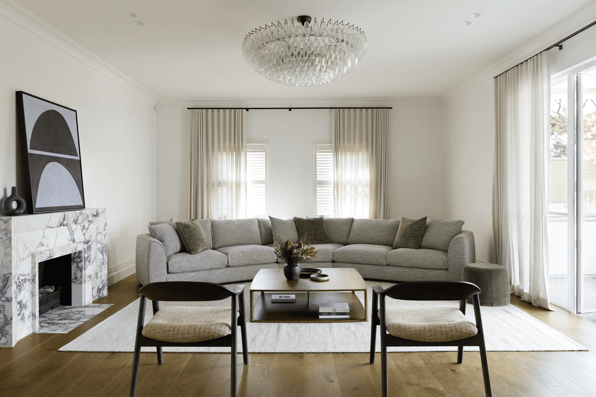 The Erskine sofa featuring a 30 Degrees Module, a fresh addition to the existing Erskine modular sofa. Placed at the centre of the sofa layout, this new module forms an impressive, curved sofa, perfect for larger spaces. This sofa is complemented by the new Karm Lounge Chairs, also presented in the smoked oak stain.